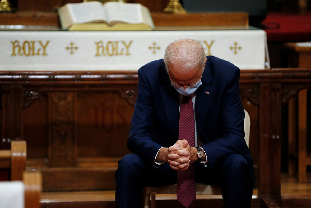 Then-Democratic presidential candidate and former Vice President Joe Biden wears a protective face mask as he bows in prayer at the Bethel AME Church June 1 in Wilmington, Delaware. (CNS/Jim Bourg, Reuters)