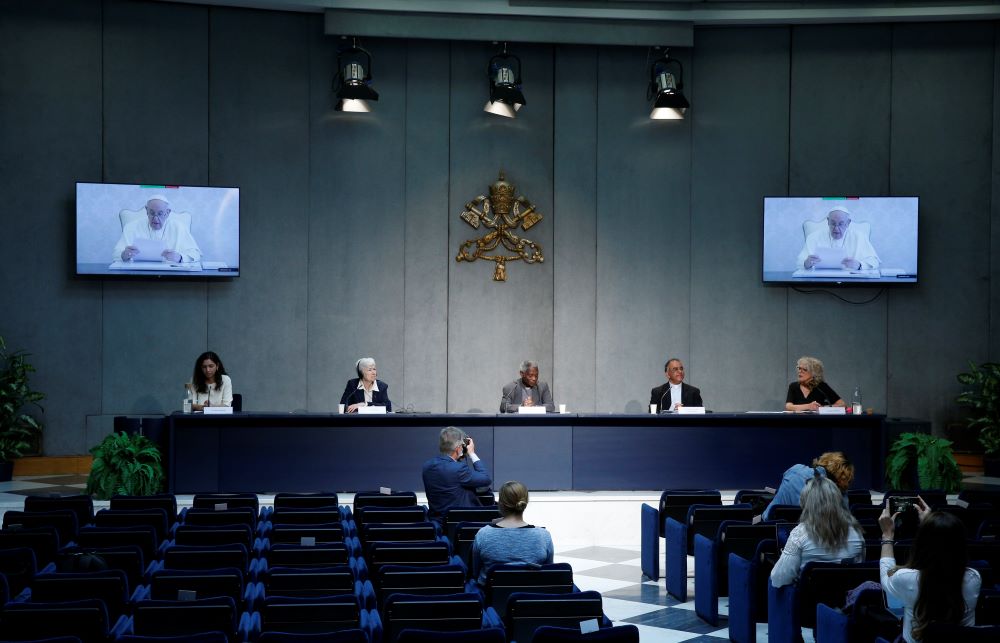 news conference with Pope Francis on screen
