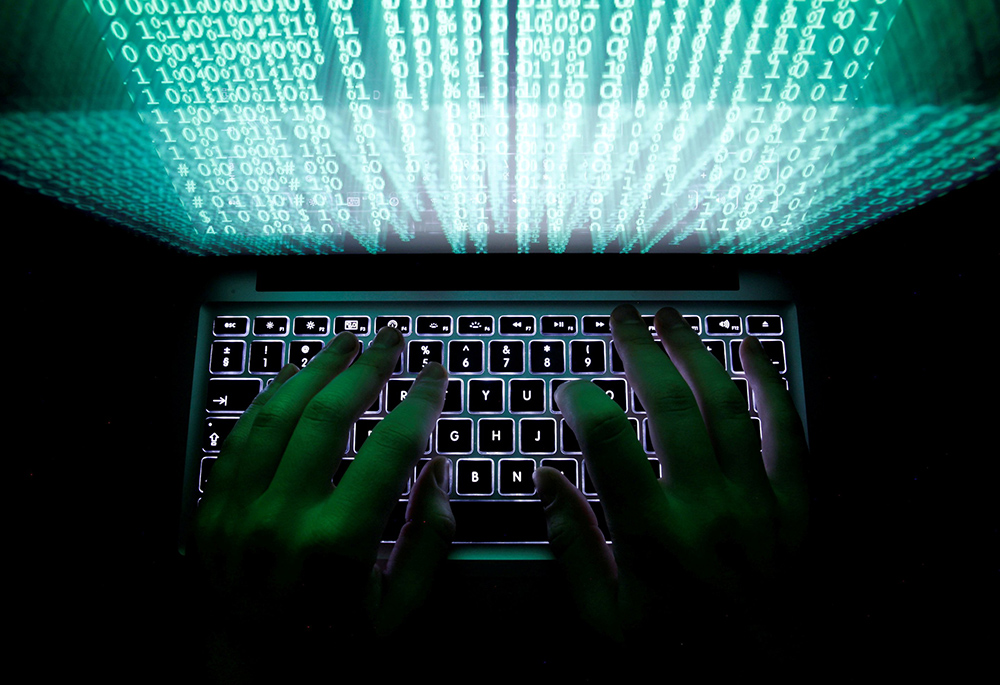 A man types on a computer keyboard in this illustration photo. (CNS/Reuters/Kacper Pempel)