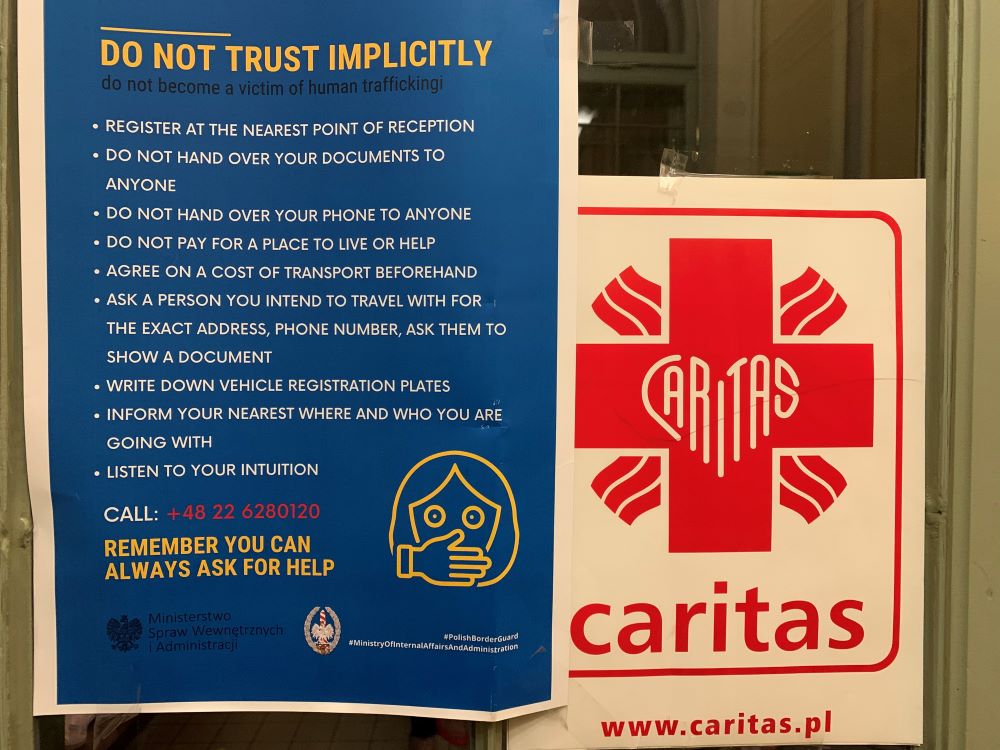 A sign on the office of Caritas at the train station in the Polish border town of Przemysl instructs Ukrainian refugees, especially women, on how to avoid becoming victims of trafficking or falling into the clutches of unscrupulous people in this April 21, 2022, photo. (CNS/Cindy Wooden)