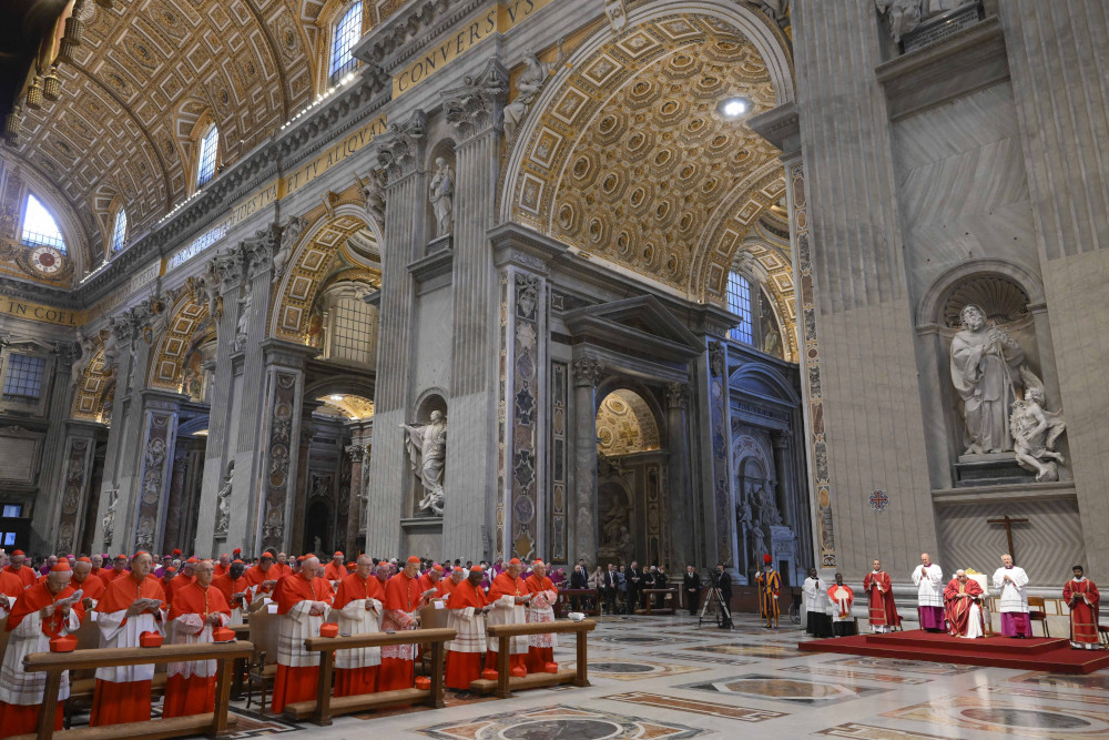 Many men dressed in red and white sit beneath the towering domed ceilings of a cathedral