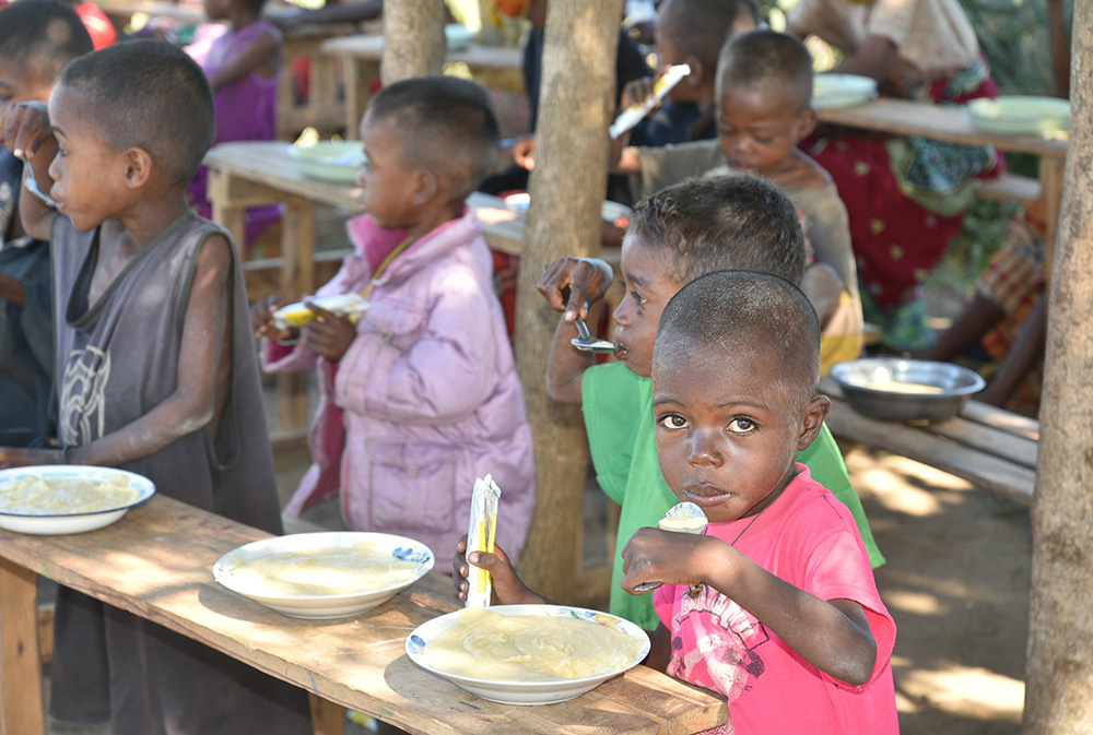 Children eat rations of food in Sihanamaro, Madagascar, during an emergency distribution of hot meals to the elderly and malnourished children in the drought-affected regions of southern Madagascar, April 29, 2021. (CNS/Courtesy of World Food Program/Krystyna Kovalenko)