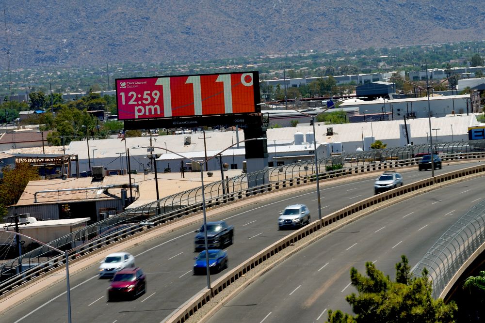 A digital billboard displays an unofficial temperature, July 17, 2023, in downtown Phoenix. Millions of people around the Southwest are living through a historic heat wave. (AP Photo/Matt York)