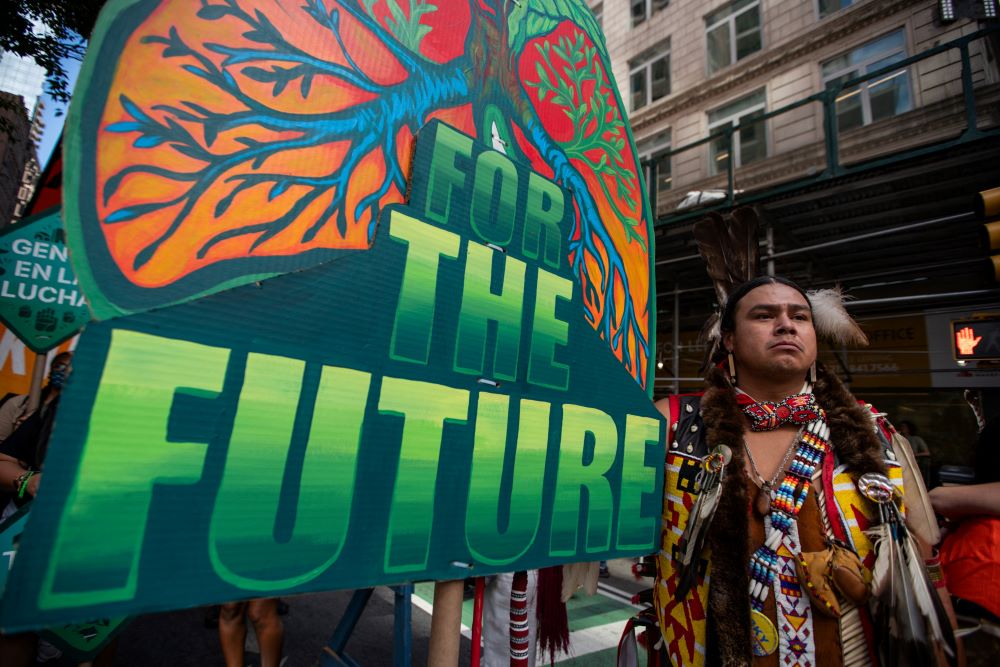 An Indigenous man holds a sign as activists mark the start of Climate Week in New York City Sept. 17, 2023, during a demonstration calling for the U.S. government to take action toward ending fossil fuel use in order to reduce the impact of global climate change. (OSV News Photo/Eduardo Munoz, Reuters)