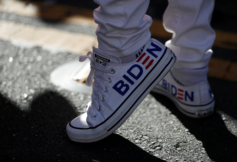 A Joe Biden supporter in San Francisco wears sneakers with his name on them Nov. 7, 2020, after news media declared the Democrat the winner of the presidential election. (CNS/Reuters/Stephen Lam)