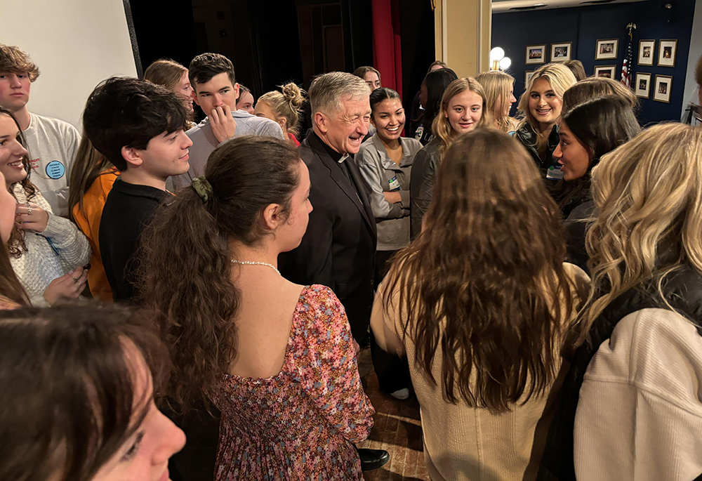 Students speak informally and pose for selfies with Cardinal Blase Cupich after a Q&A session with the cardinal during the third annual Catholic Youth Climate Summit in Chicago on Feb. 25. (Courtesy of Catholic Climate Covenant)