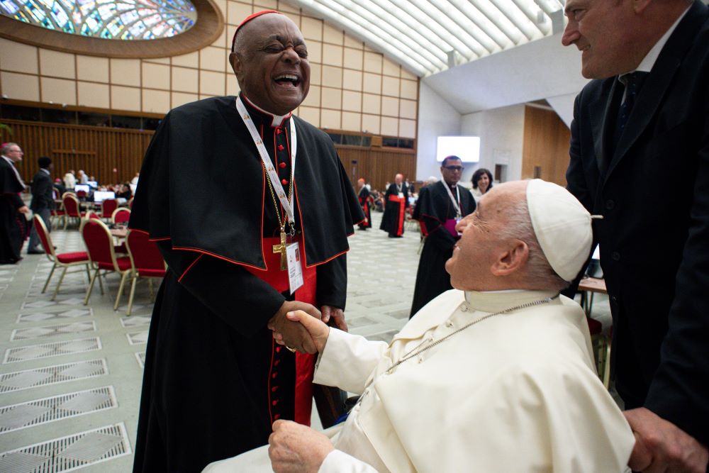 Cardinal Wilton Gregory of Washington and Redemptorist Fr. Vimal Tirimanna of Sri Lanka work during a break at the assembly of the Synod of Bishops in the Vatican's Paul VI Audience Hall Oct. 10.