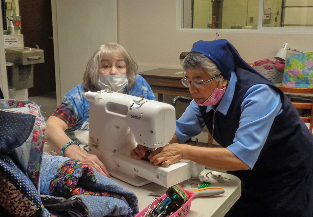 Sr. Milagros Federico assists a student in a sewing class at Give Me a Chance, a nonprofit operated by the Daughters of Charity of St. Vincent de Paul that empowers low-income women and children. (Courtesy of Give Me a Chance/Marissa Konkol)
