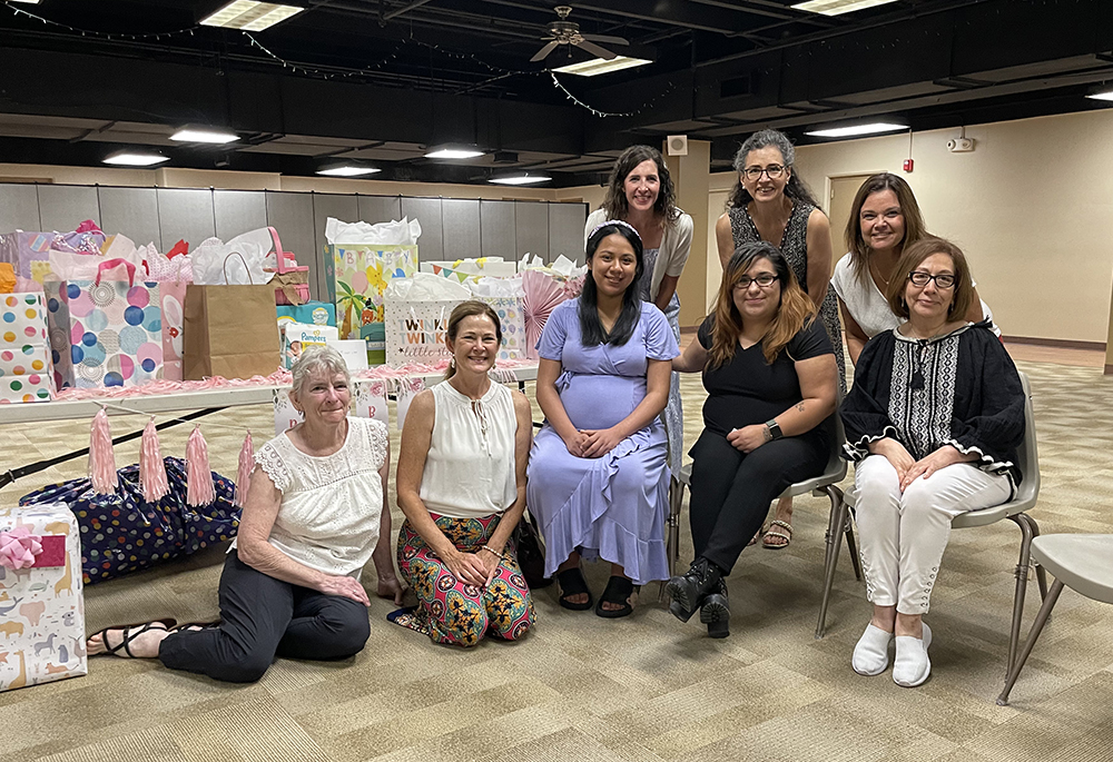Members of Walking with Moms in Need groups, from Queen of the Rosary Parish in Overland Park, Kansas, and Church of the Nativity in Leawood, Kansas, throw a baby shower for an expecting mom. (Courtesy of Katie O’Hara)