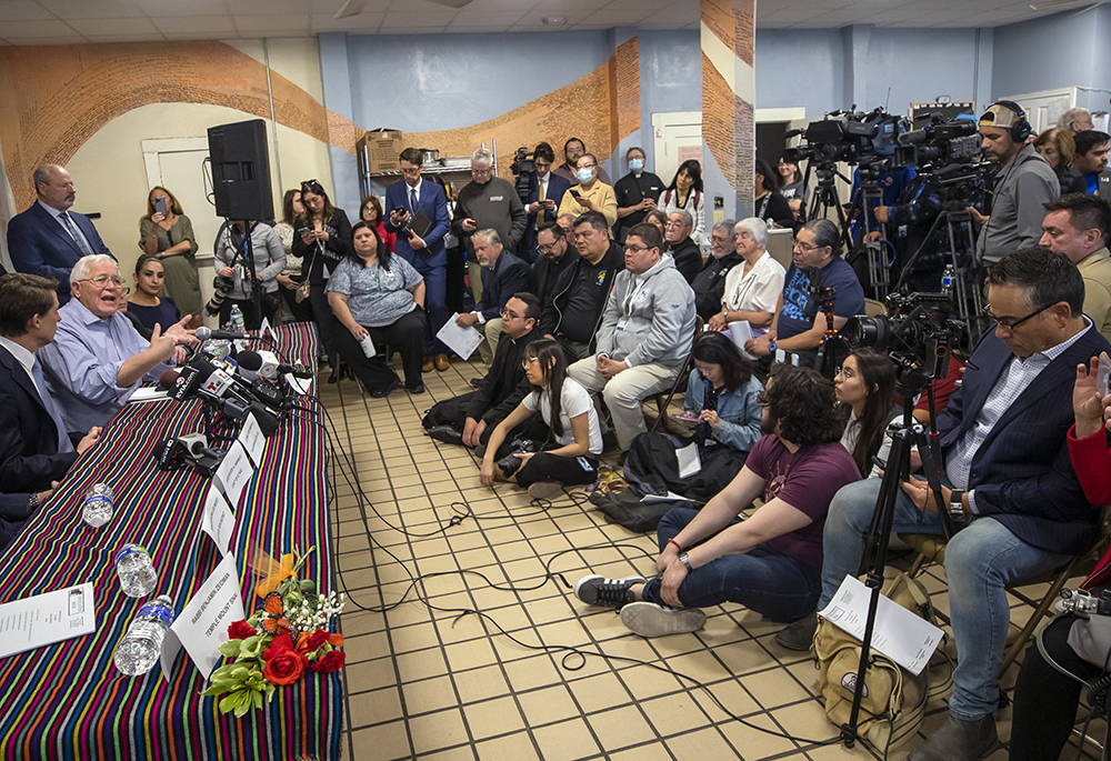Ruben Garcia, second from left, founder and director of Annunciation House, a network of migrants shelters in El Paso, Texas, speaks during a news conference Feb. 23. Garcia is reacting to the lawsuit filed by Texas Attorney General Ken Paxton that claims the Annunciation House "appears to be engaged in the business of human smuggling" and is threatening to terminate the nonprofit's right to operate in Texas. (AP photo/Andres Leighton)