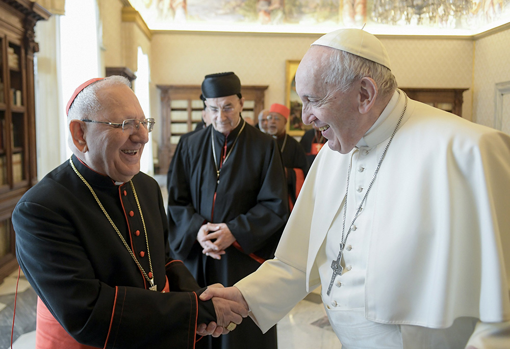 Pope Francis greets Iraqi Cardinal Louis Sako, patriarch of the Chaldean Catholic Church, in the library of the Apostolic Palace at the Vatican Feb. 18, 2022. (CNS/Vatican Media)