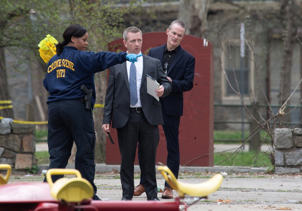 Law enforcement officials examine scene of shooting