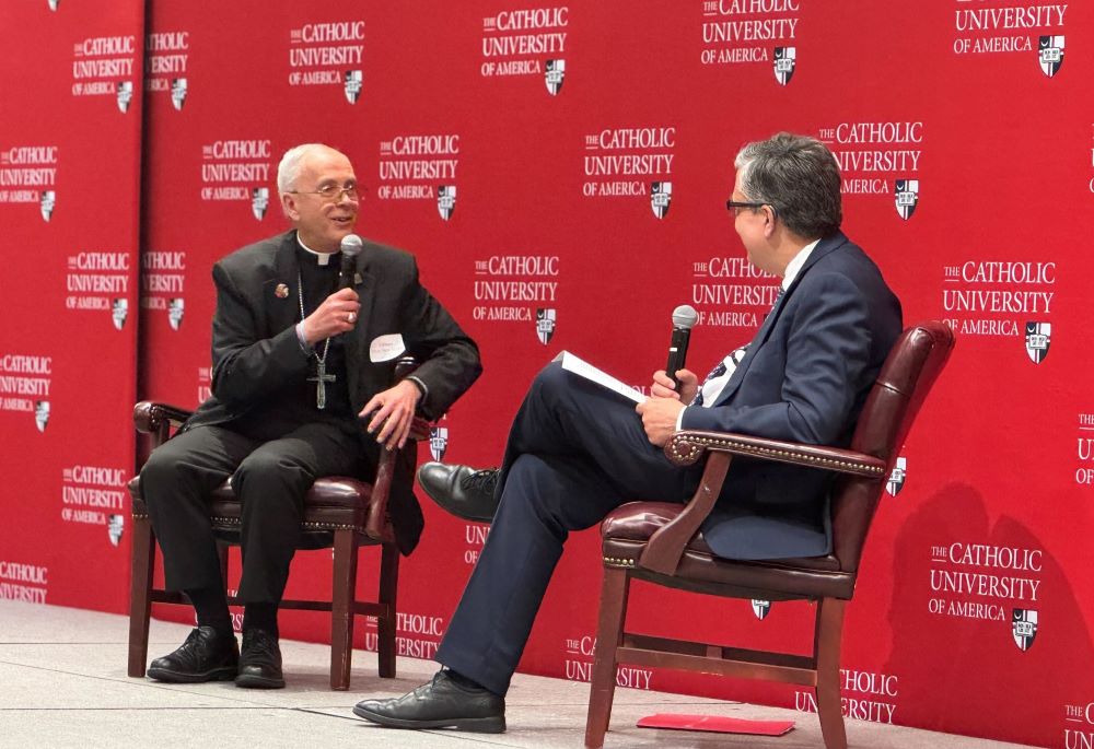 El Paso Bishop Mark Seitz, left, talks with Peter K. Kilpatrick, president of The Catholic University of America, during a daylong conference on immigration the university hosted with the U.S. Conference of Catholic Bishops April 11 in Washington.