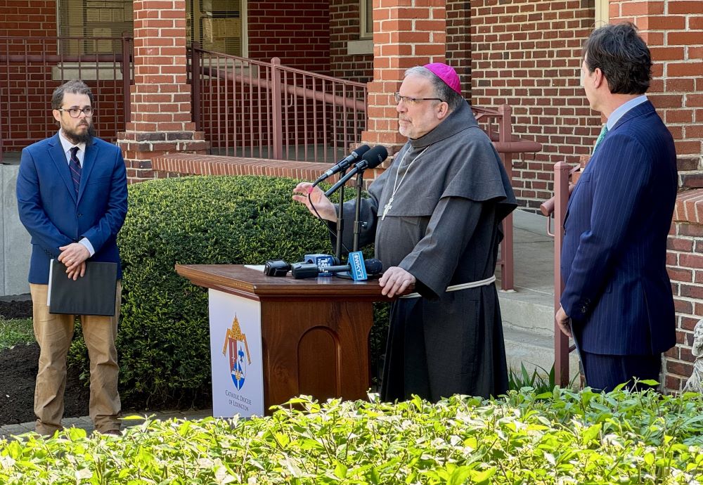 Bishop John Stowe of Lexington, Kentucky, center, speaks at a press conference. With him are Adam Edelen (right), founder and CEO of Edelen Renewables, and Joshua Van Cleef (left).