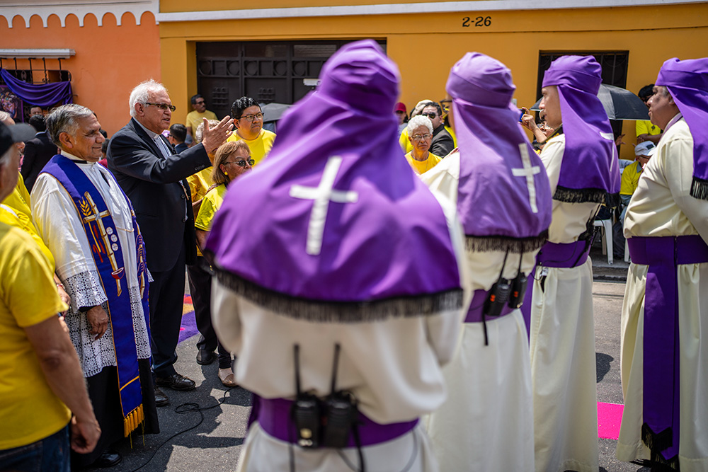 Cardinal Álvaro Ramazzini, with a raised arm, delivers an impromptu speech to members of the Jesus del Consuelo brotherhood during their annual procession in Guatemala City March 23. (AP/Moises Castillo)