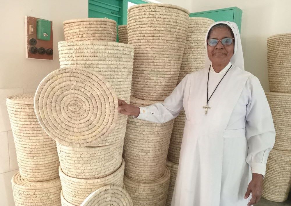 Sr. Jacinta Costa, a member of the Sisters of Charity of Sts. Bartolomea Capitanio and Vincenza Geroza, stands with products women make at Valerian Handicrafts Centre in Jessore, Bangladesh. 