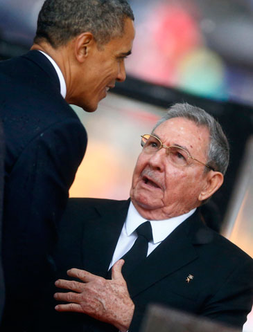 U.S. President Barack Obama greets Cuban President Raul Castro in Johannesburg Dec. 10. (CNS/Reuters/Kai Pfaffenbach)