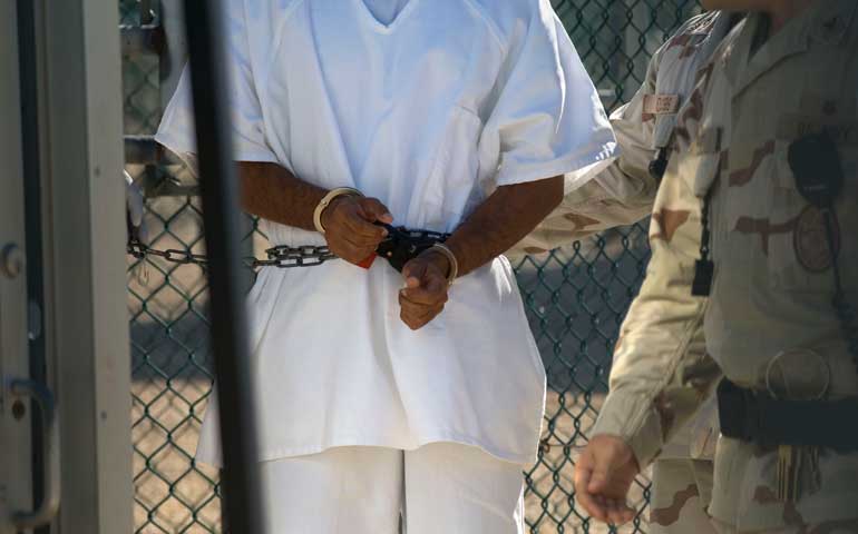 A detainee seen in hand restraints in Camp 4 at the U.S. detention facility in Guantánamo Bay, Cuba, in 2008. (Newscom/ZUMA Press/Louie Palu)