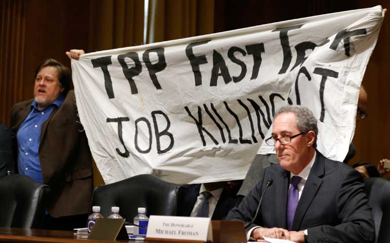 A police officer removes a man protesting the Trans-Pacific Partnership as U.S. Trade Representative Michael Froman testifies before a Senate Finance Committee on Capitol Hill in Washington Jan. 27. (Newscom/Reuters/Kevin Lamarque)