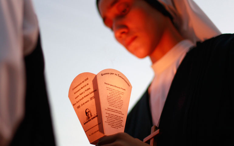 A nun holds a candle as she takes part in a march prior to the 33rd anniversary of the murder of Archbishop Oscar Romero in San Salvador, El Salvador, March 16.  (CNS/Reuters/Ulises Rodriguez)