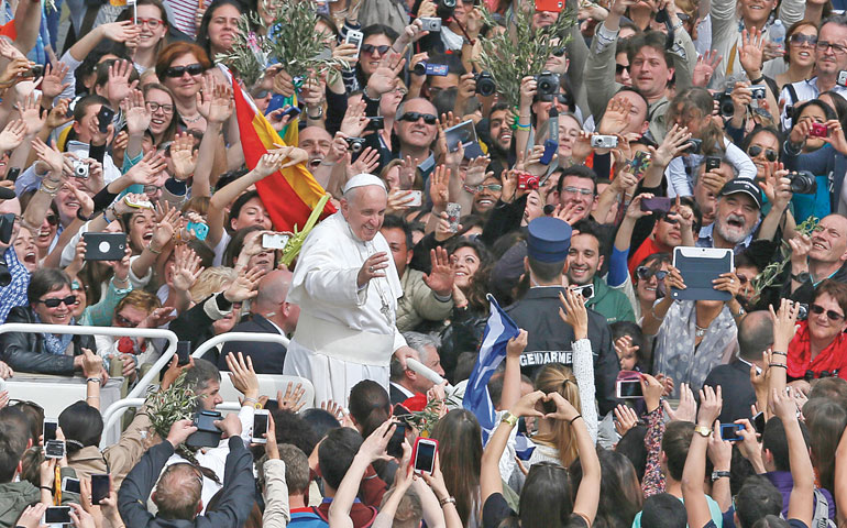 Pope Francis greets the crowd after celebrating Palm Sunday Mass in St. Peter's Square at the Vatican April 13. (CNS/Paul Haring)