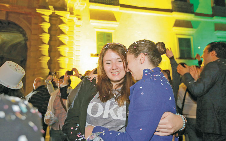 People celebrate after Malta's parliament voted to recognize same-sex partnerships in Valletta April 14. (CNS/Reuters/Darrin Zammit Lupi)