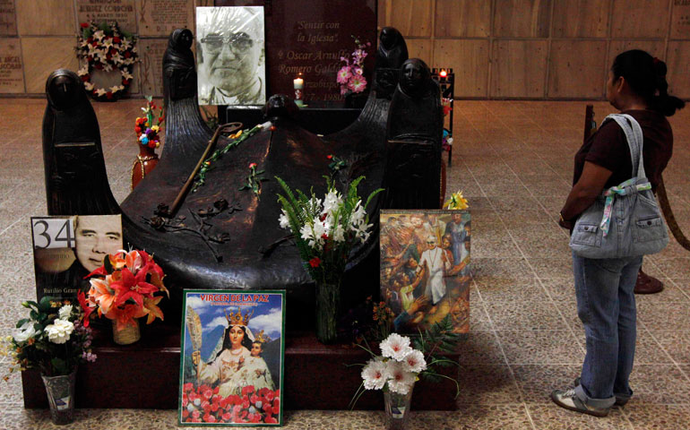 A tourist visits the tomb of Archbishop Oscar Romero in San Salvador in 2011. (CNS/Reuters/Luis Galdamez)