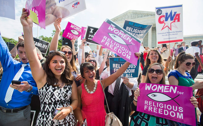 In Washington June 30, Hobby Lobby supporters cheer the 5-4 ruling by the Supreme Court in favor of the craft store chain that challenged the Affordable Care Act's mandate that employee health plans include contraceptive coverage. (EPA/Jim Lo Scalzo)