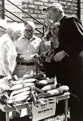 In 1975, Bishop Raymond Lucker, then auxiliary of St. Paul-Minneapolis, encourages passersby to help themselves to corn, cucumbers and beans from his farm. (CNS/Kati Ritchie)