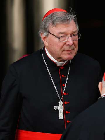Cardinal George Pell leaves the morning session of the Synod of Bishops Oct. 16. (CNS photos/Paul Haring)