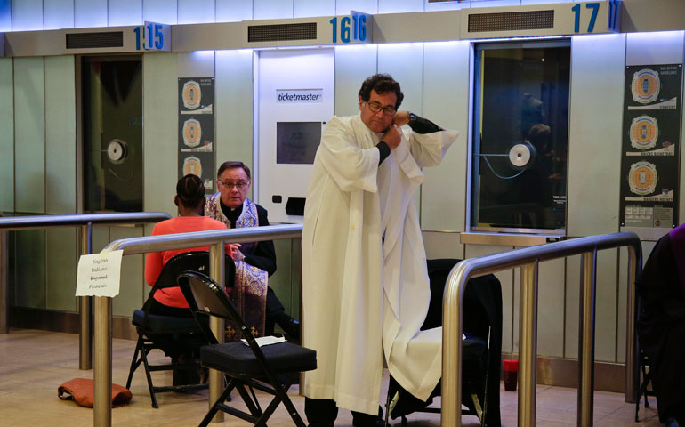 A priest prepares to hear confessions before the start of a Mass to be celebrated by Pope Francis at Madison Square Garden in New York Sept. 25. (Newscom/Polaris)