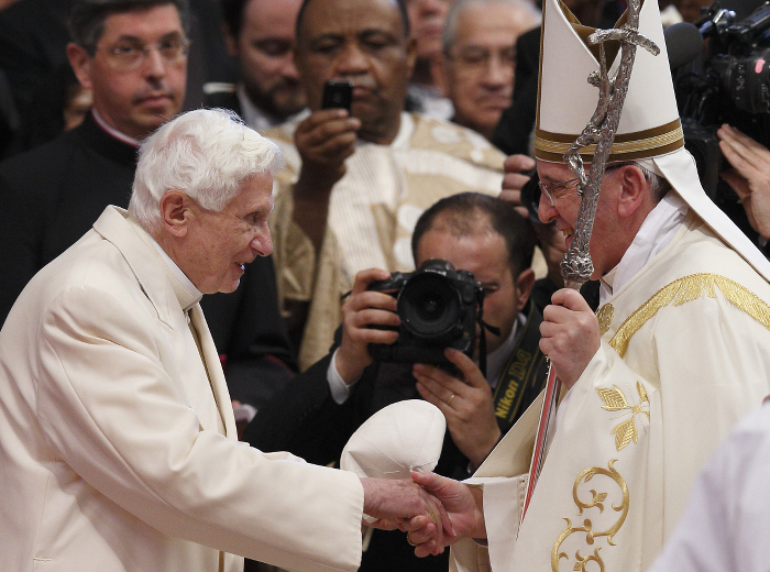 Retired Pope Benedict XVI greets Pope Francis at the conclusion of a consistory at which Pope Francis created 19 new cardinals in St. Peter's Basilica at the Vatican Feb. 22. (CNS photo/Paul Haring)