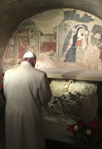 Pope Francis prays in front of a Nativity scene during surprise visit to the Franciscan shrine in Greccio, Italy. (CNS/L'Osservatore Romano, handout via EPA) 