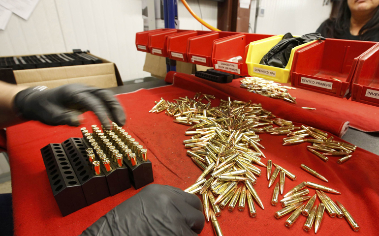 A worker puts finished 300 AAC Blackout rounds into packaging Jan. 7 at Barnes Bullets in Mona, Utah. (CNS/George Frey, Reuters)
