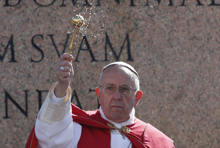 Pope Francis blesses with holy water as he leads a service at the obelisk at the beginning of Palm Sunday Mass in St. Peter's Square at the Vatican March 20. (CNS/Paul Haring)