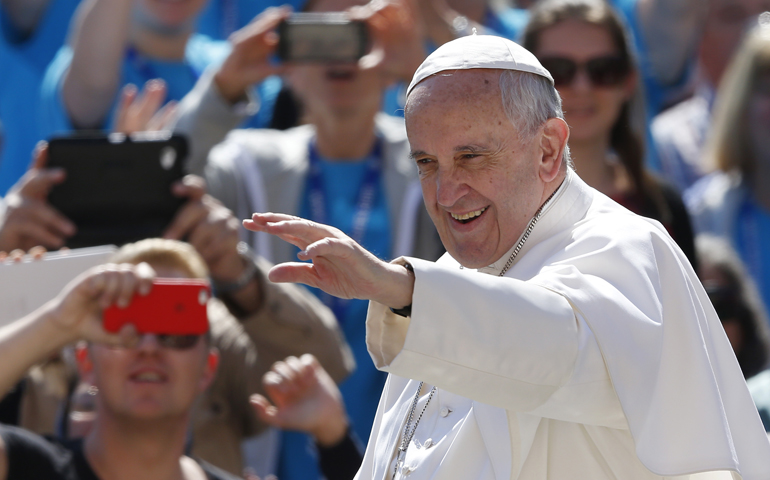 Pope Francis greets the crowd during his general audience in St. Peter's Square at the Vatican May 18. (CNS/Paul Haring)