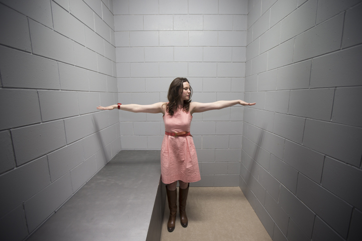 The Rev. Laura Markle Downton, director of the U.S. Prisons Policy and Program at the National Religious Campaign Against Torture, is pictured in a replica solitary confinement cell during the Ecumenical Advocacy Days event in 2015. (CNS/Erin Schaff, Perisphere Media) 