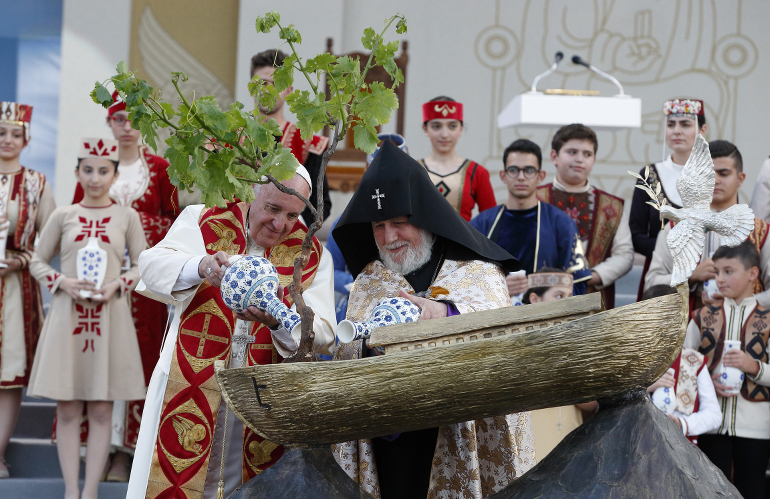 Pope Francis and Catholicos Karekin II, patriarch of the Armenian Apostolic Church, pour water on a tree in a model of Noah's Ark during an ecumenical meeting and prayer for peace in Republic Square in Yerevan, Armenia, June 25. (CNS photo/Paul Haring)