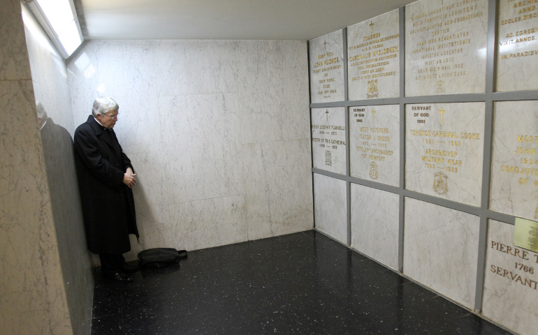 Fr. Charles Connor prays before the tomb of Archbishop Fulton Sheen in the crypt of St. Patrick's Cathedral in New York in this 2009 photo. (CNS/Gregory A. Shemitz) 