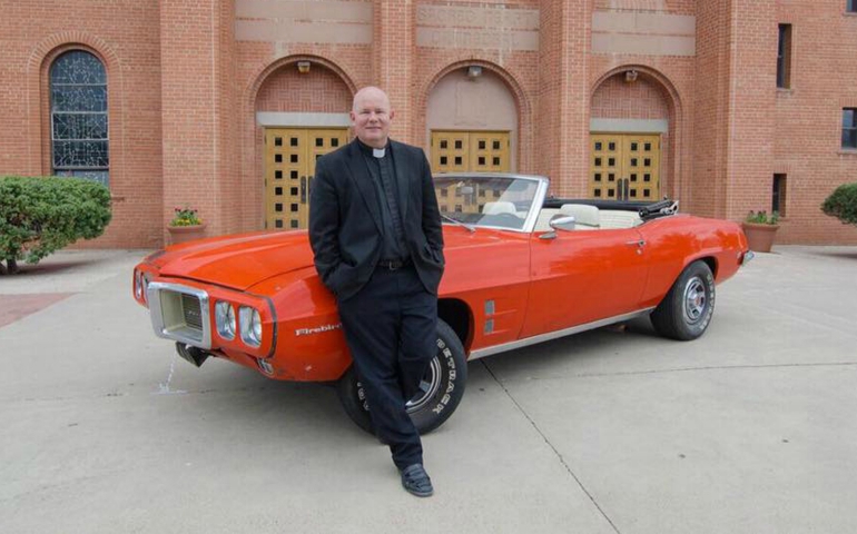 Fr. Matthew Keller poses June 8 with a 1969 Pontiac Firebird Convertible that he refurbished for a raffle in support of vocations for the Diocese of Gallup, New Mexico. (CNS/V8 for Vocations)