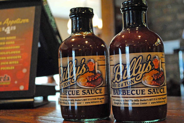Sales of Billy's Hit-It-A-Ton barbecue sauce eclipsed 48,000 bottles in its first year of sales, resulting in $32,000 donated to Bishop Sullivan Center. The funds help to feed local families and offer emergency assistance for basic needs. (NCR photo/Brian Roewe)