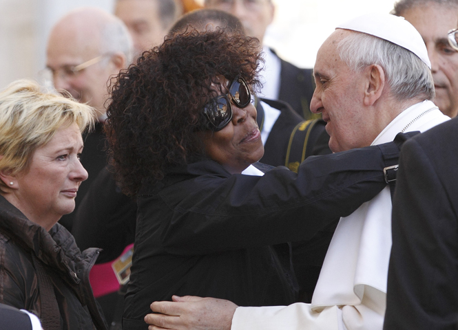 Patience Dodo of Gabon, who is blind, hugs Pope Francis on Wednesday as he leaves his general audience in St. Peter's Square at the Vatican. (CNS/Paul Haring) 