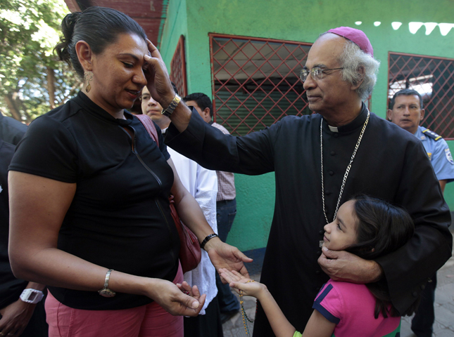Cardinal-designate Leopoldo Brenes Solorzano of Managua, Nicaragua, blesses a woman in Tipitapa Jan. 15. (CNS/Reuters/Oswaldo Rivas)