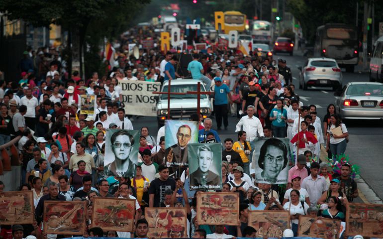 People carry images and banners during a March 26 procession in San Salvador, El Salvador, to commemorate the 37th anniversary of the murder of Blessed Oscar Romero, who was shot and killed March 24, 1980, as he celebrated Mass. (CNS photo/Jose Cabezas, Reuters)