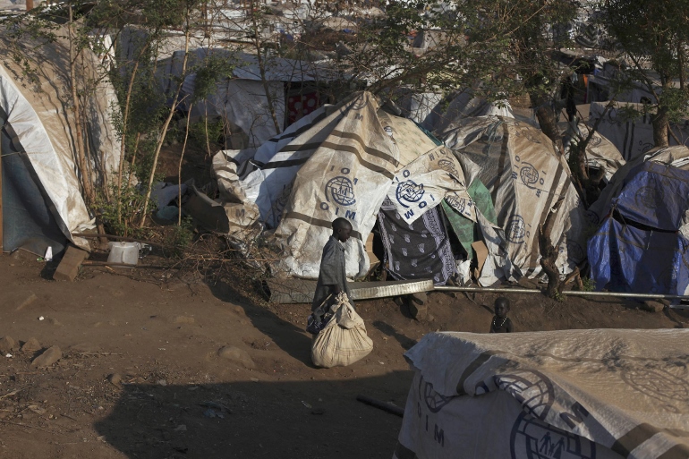 Children walk past tents in one of the two U.N. mission compounds that are holding displaced people in Juba, South Sudan, Jan. 27. (CNS photo/Andreea Campeanu, Reuters) 