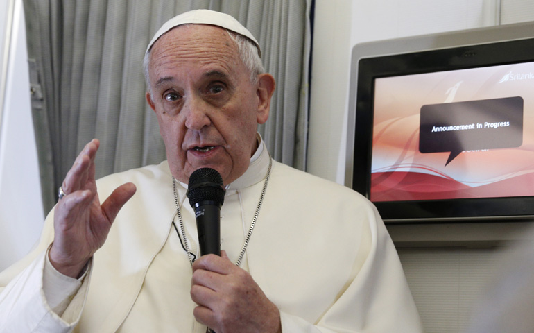 Pope Francis answers questions from the media Thursday aboard his flight to Manila, Philippines. (CNS/Paul Haring) 