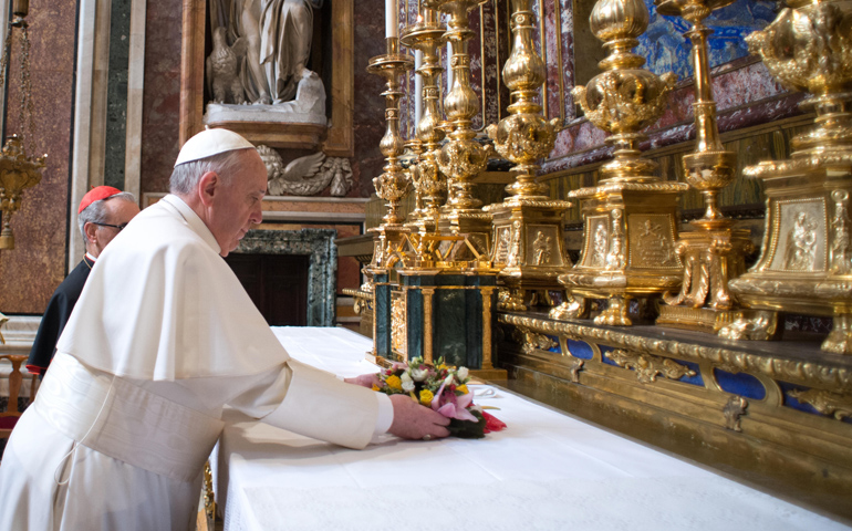 Newly elected Pope Francis leaves flowers in front of the "Salus Populi Romani" ("Salvation of the Roman People"), a Marian icon, in a chapel of the Basilica of St. Mary Major on Thursday in Rome. (CNS/L'Osservatore Romano)