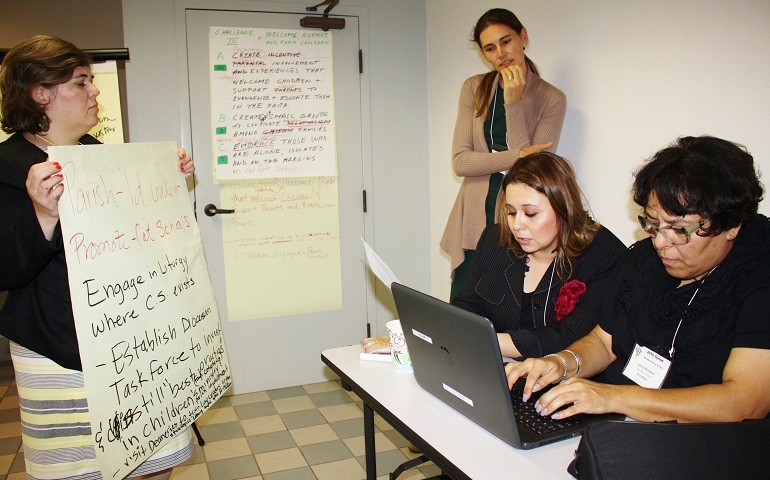 From left, Erika Mayoral, Maureen Day, Marioly Galvan and Leticia Mendoza put the finishing touches on their group's proposals to welcome, nurture and form children, during the San Diego synod Oct. 30. (Courtesy of the San Diego diocese/Aida Bustos)