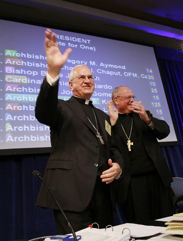 Archbishop Joseph Kurtz of Louisville, Ky., is elected the new president of the U.S. Conference of Catholic Bishops on Tuesday in Baltimore, succeeding New York Cardinal Timothy Dolan, right. (CNS/Nancy Phelan Wiechec)