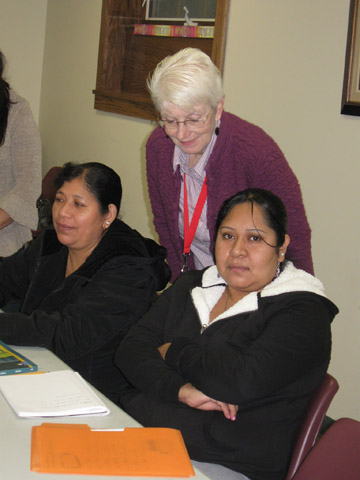 Sr. Mary Beth Moore, standing, coaches women in a literacy program 